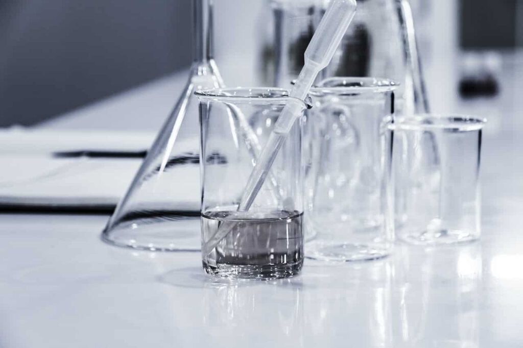 clear beakers with contaminated water used for PFAS testing and treatment