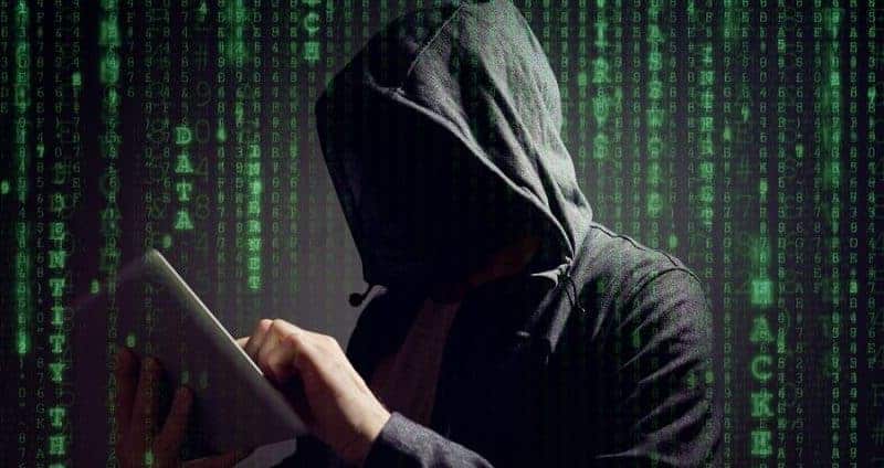 Computer hacker with digital tablet stealing data