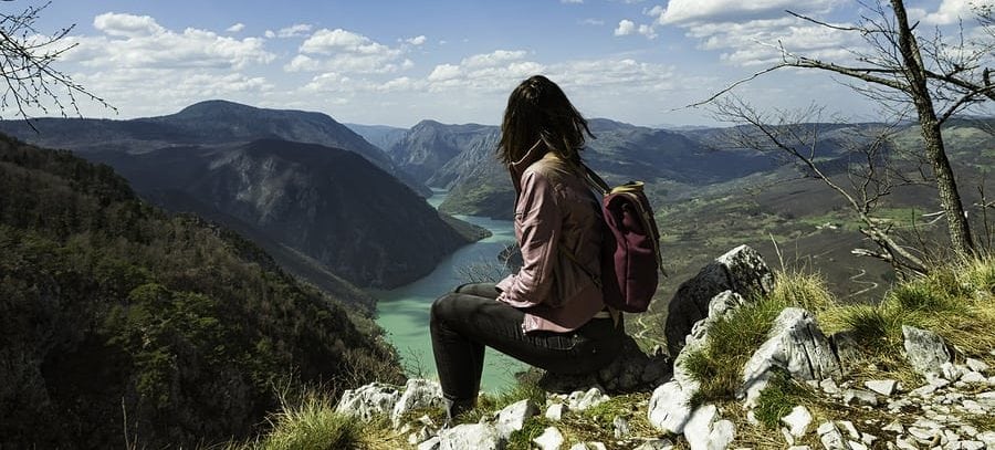 girl travelling on mountaintop alone e1535551282919