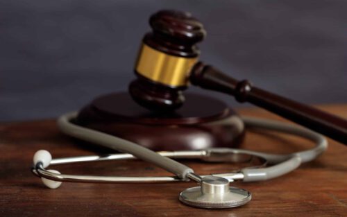 judge gavel and a stethoscope on a wooden desk 2021 08 26 16 34 02 utc scaled e1639682897163