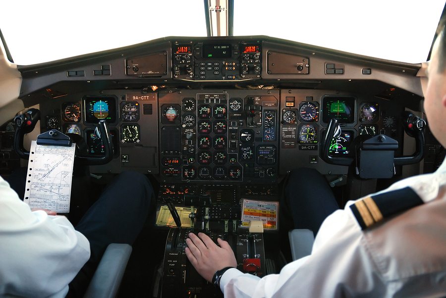 pilots in cockpit of plane