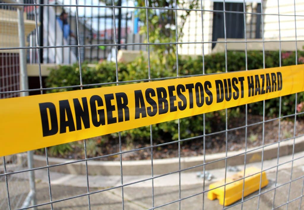 Yellow tape that says danger asbestos dust hazard