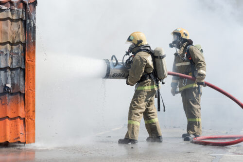 firefigters using pfas based foam against fire